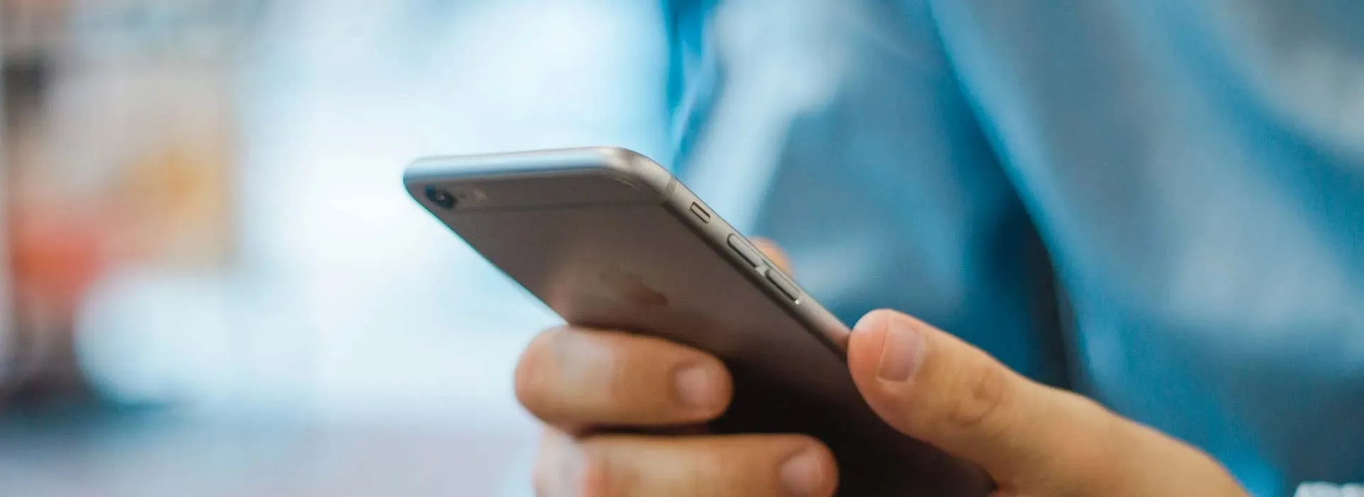 A hand holding a smartphone